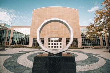 View of JHE through the iron ring sculpture.