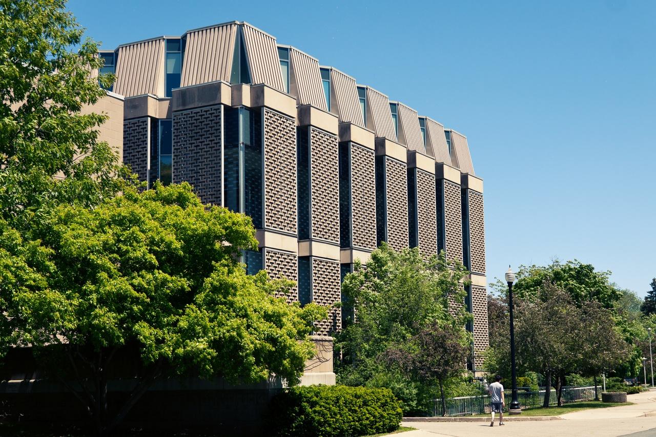 Angled view of the rear of Mills Library with greenery.